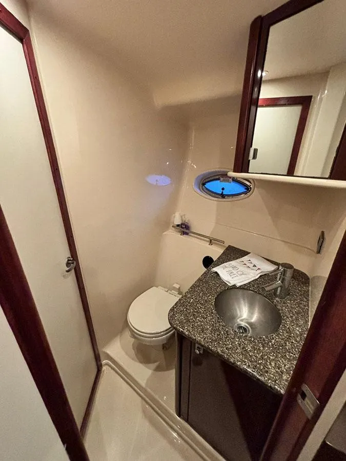 Slide: The Image of 2008 Sea Ray 38 Sundancer bathroom with granite countertop and stainless steel sink. - 30