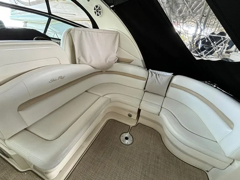 Slide: The Image of Luxurious interior seating of 2008 Sea Ray 38 Sundancer yacht, featuring elegant white upholstery. - 8