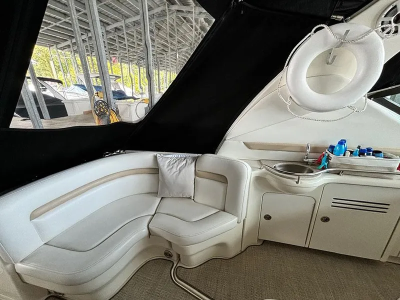 Slide: The Image of Interior of 2008 Sea Ray 38 Sundancer with white seating and kitchenette. - 9
