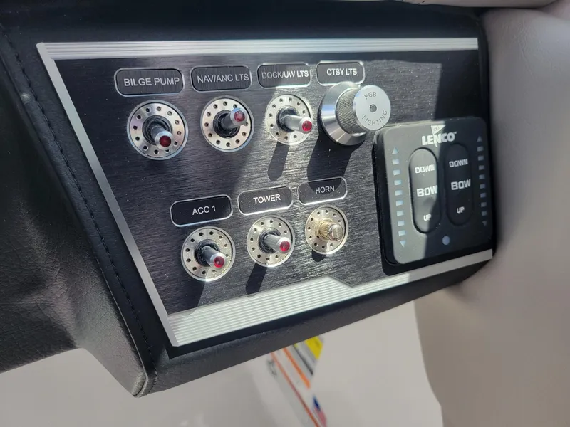 Slide: The Image of Control panel of 2024 Four Winns HD5 OB boat with various switches and Lenco trim tab controls. - 12