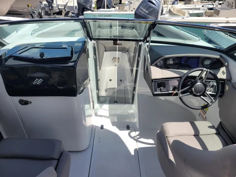 Slide: The Image of 2024 Four Winns HD5 OB boat interior with steering wheel and seating. - 16