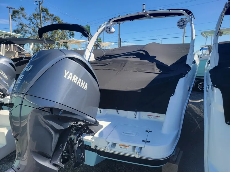 Slide: The Image of 2024 Four Winns HD5 OB boat with Yamaha outboard motor, covered and docked. - 18