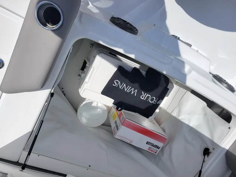 Slide: The Image of 2024 Four Winns HD5 OB storage compartment with cooler and accessories. - 7