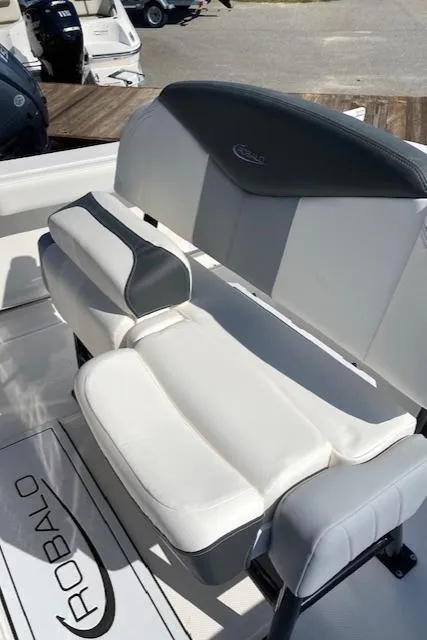 Slide: The Image of 2024 Robalo R222 Center Console boat seating area with white and gray upholstery. - 15