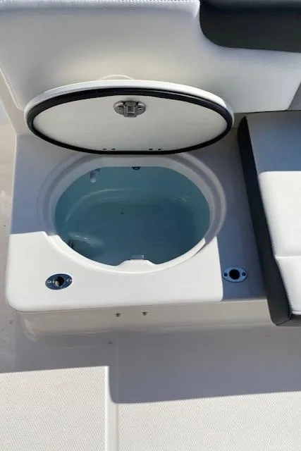 Slide: The Image of 2024 Robalo R222 Center Console livewell with open lid. - 19