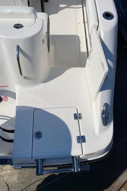 Slide: The Image of 2024 Robalo R222 Center Console boat deck with storage compartments and stainless steel hardware. - 23
