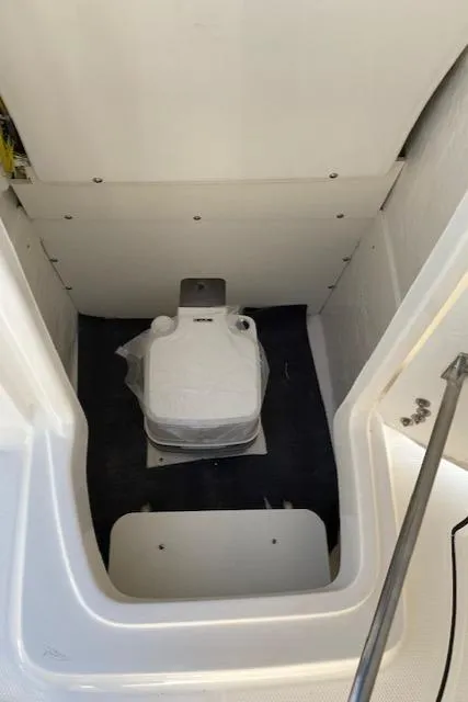 Slide: The Image of 2024 Robalo R222 Center Console boat interior with marine toilet. - 7