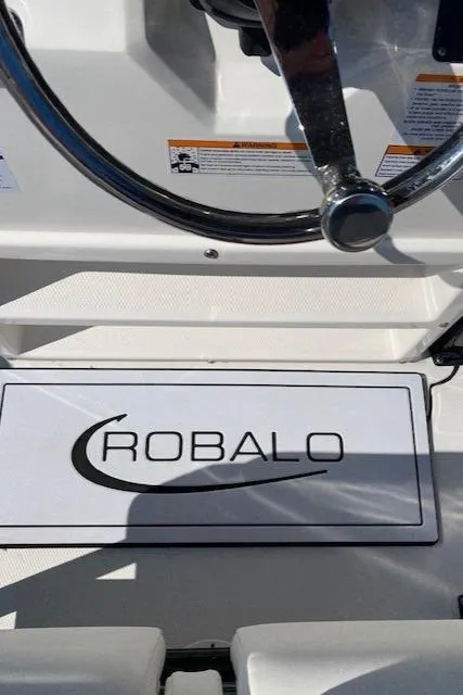 Slide: The Image of 2024 Robalo R222 Center Console boat steering wheel and logo. - 16