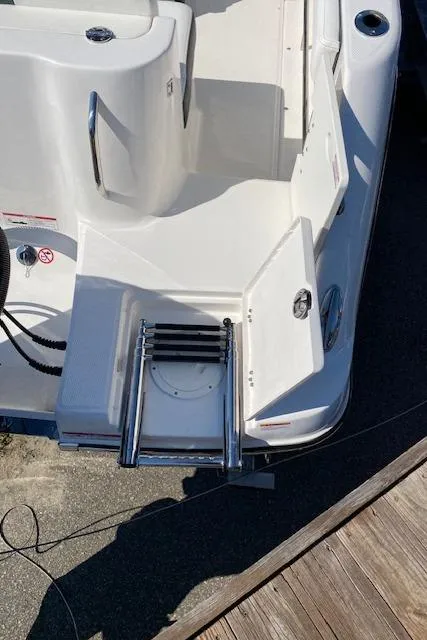 Slide: The Image of 2024 Robalo R222 Center Console boat with swim ladder and storage compartments. - 22