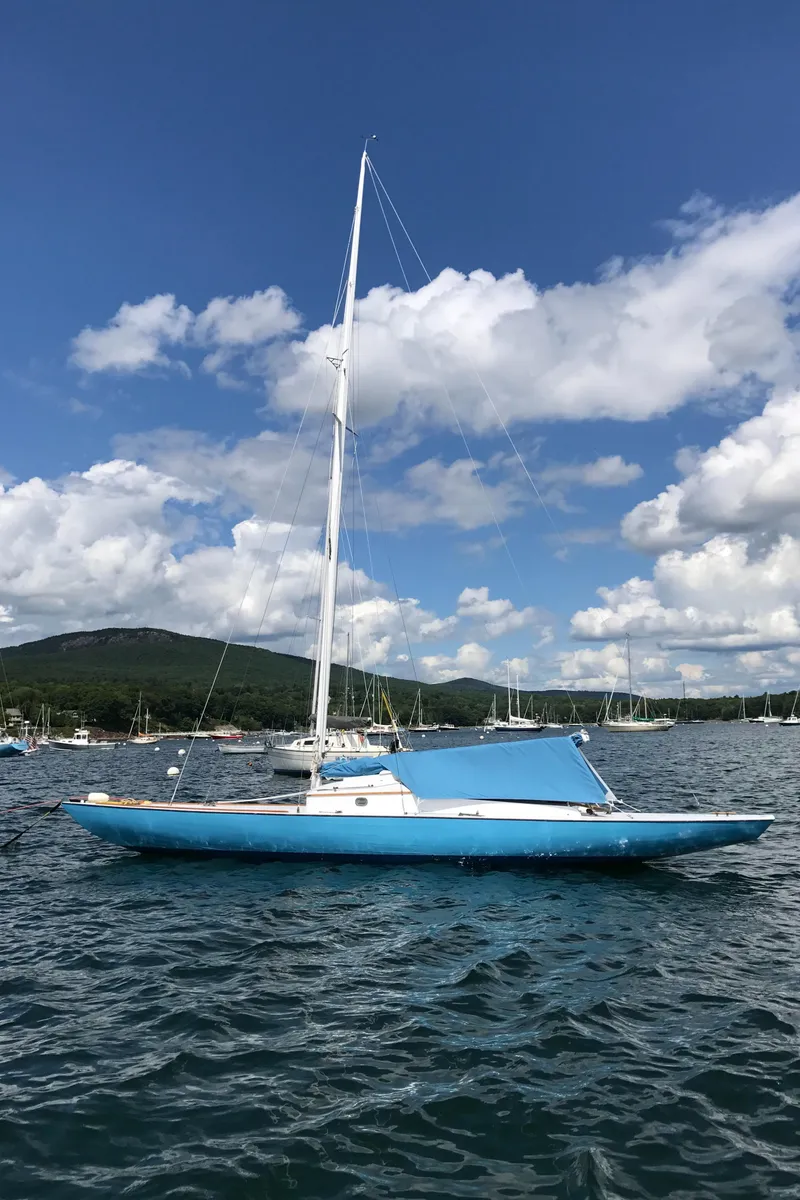 Slide: The Image of Classic 1930 Camden Haj Class sailboat on water under blue sky and clouds. - 4