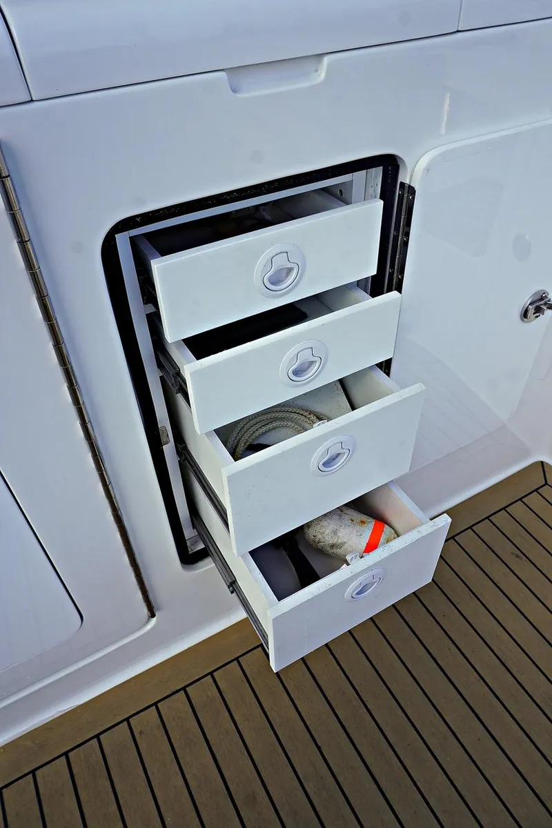 Slide: The Image of Four open storage drawers on a 2022 Henriques 42EXHT boat. - 18