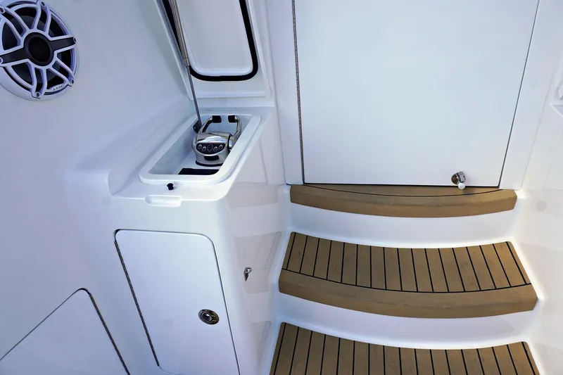 Slide: The Image of Henriques 42EXHT 2022 boat interior with teak steps and built-in storage. - 25