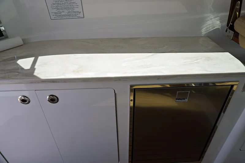 Slide: The Image of Henriques 42EXHT 2022 yacht interior with marble countertop and built-in fridge. - 38
