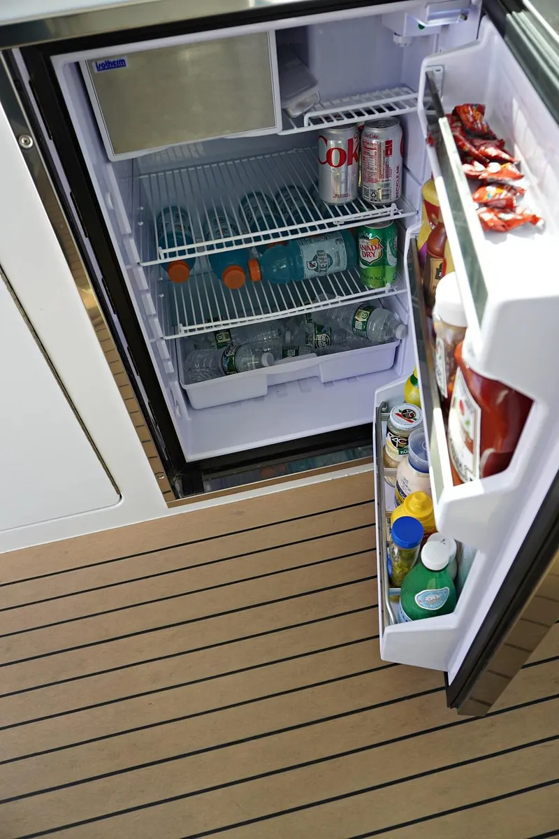 Slide: The Image of Open refrigerator on Henriques 42EXHT 2022 boat, stocked with beverages and condiments. - 39