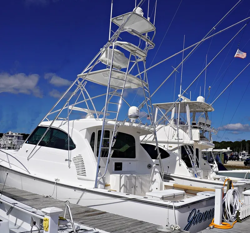 Slide: The Image of Henriques 42EXHT 2022 model yacht docked at marina under clear blue sky. - 4