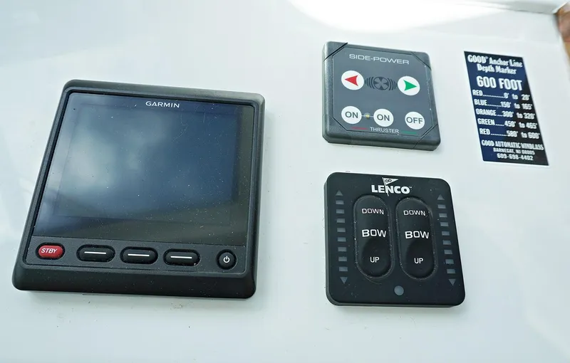 Slide: The Image of Henriques 42EXHT 2022 boat control panel with Garmin, Side-Power, and Lenco devices. - 46