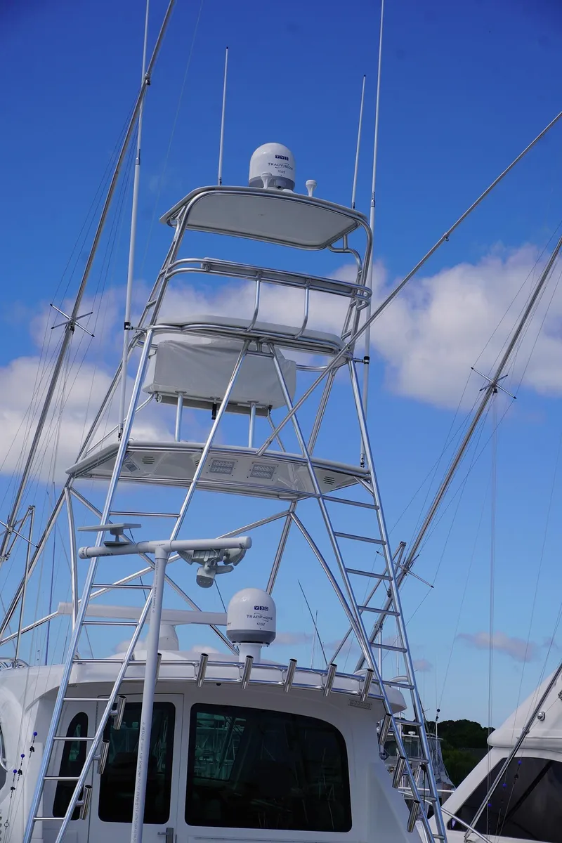 Slide: The Image of 2022 Henriques 42EXHT boat with a tall tower against a blue sky. - 5