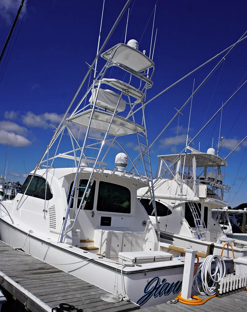 Slide: The Image of Henriques 42EXHT 2022 model sportfishing boat docked at marina. - 6