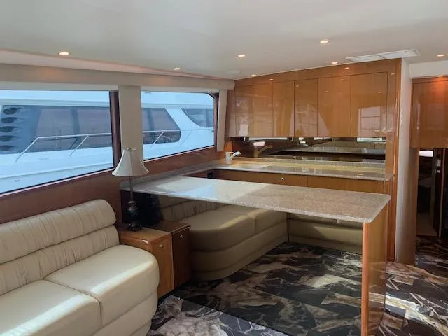 Slide: The Image of Luxurious interior of a 2002 Viking 55 Convertible yacht with elegant seating and modern kitchen. - 13