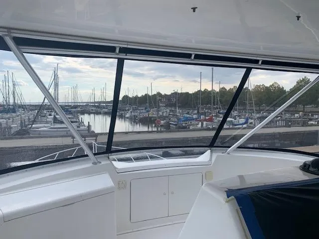Slide: The Image of View from 2002 Viking 55 Convertible yacht overlooking marina with sailboats and calm water. - 15