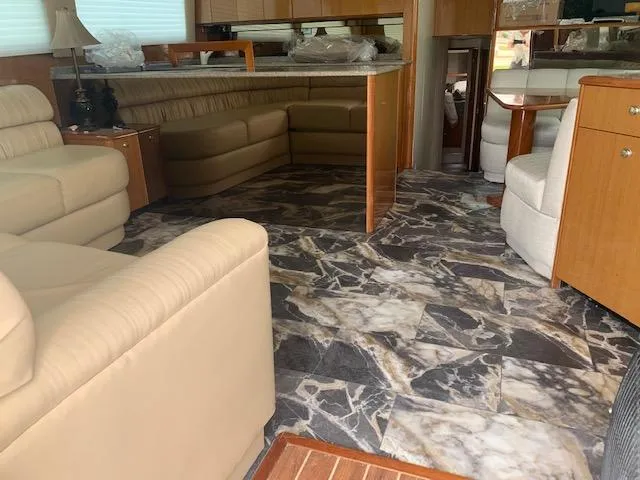 Slide: The Image of Interior of 2002 Viking 55 Convertible yacht with marble flooring and beige seating. - 19