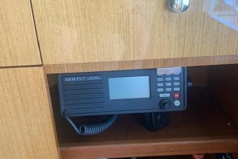 Slide: The Image of Marine radio equipment inside a 2002 Viking 55 Convertible yacht's wooden cabinet. - 23