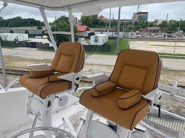 Slide: The Image of Two tan captain's chairs on a 2002 Viking 55 Convertible yacht. - 3