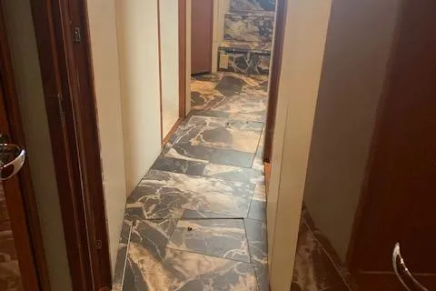 Slide: The Image of Hallway with marble flooring inside a 2002 Viking 55 Convertible yacht. - 31