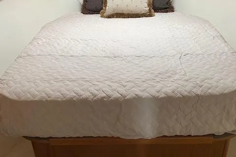 Slide: The Image of Luxurious bed with white quilted bedding in a 2002 Viking 55 Convertible yacht. - 35