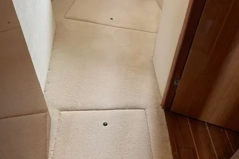 Slide: The Image of Interior hallway of a 2002 Viking 55 Convertible yacht with beige carpeting. - 36