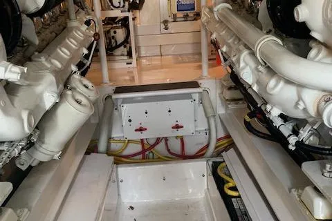 Slide: The Image of Engine room of 2002 Viking 55 Convertible yacht, showcasing dual engines and wiring. - 42