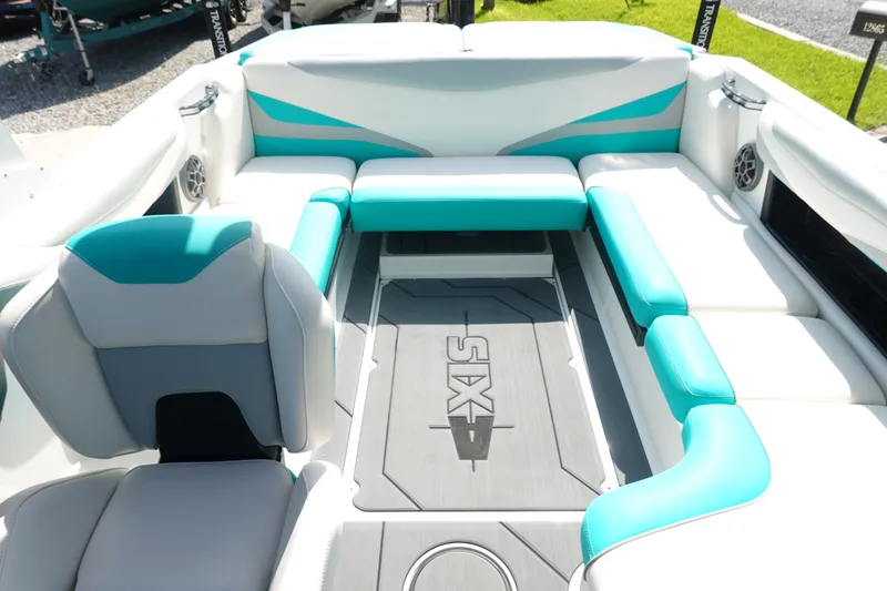 Slide: The Image of 2020 Axis T22 boat interior with teal and white seating, featuring a spacious layout. - 11