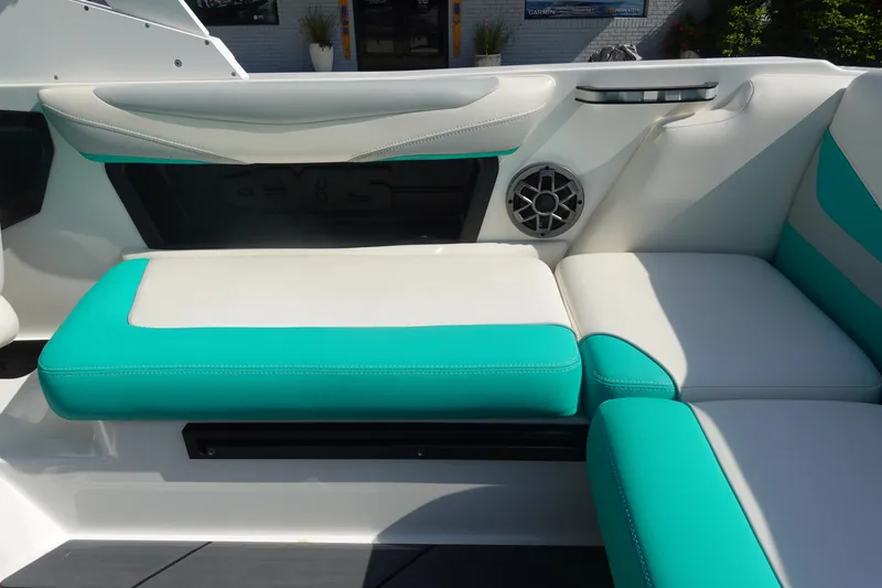 Slide: The Image of 2020 Axis T22 boat interior with teal and white seating, featuring a built-in speaker. - 13
