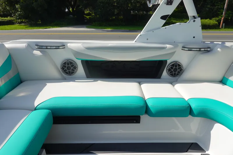 Slide: The Image of 2020 Axis T22 boat interior with teal and white seating, featuring built-in speakers. - 14