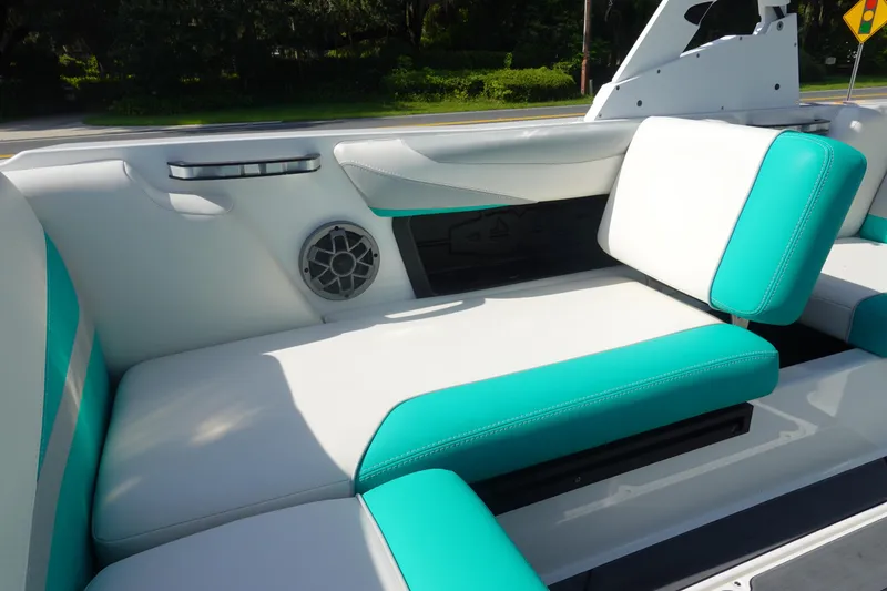Slide: The Image of 2020 Axis T22 boat interior with teal and white seating, featuring built-in speaker. - 16