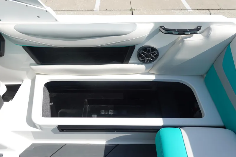 Slide: The Image of 2020 Axis T22 boat interior with open storage compartment and speaker. - 17