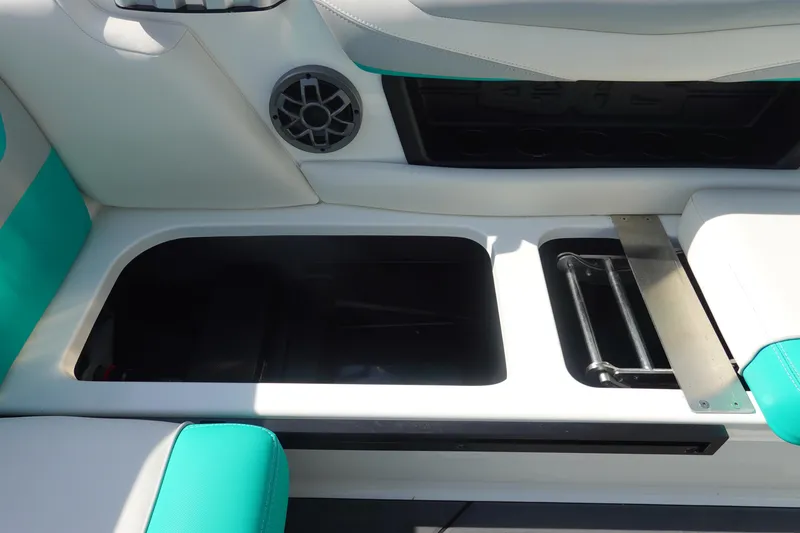 Slide: The Image of 2020 Axis T22 boat interior storage compartment with teal and white seating. - 18