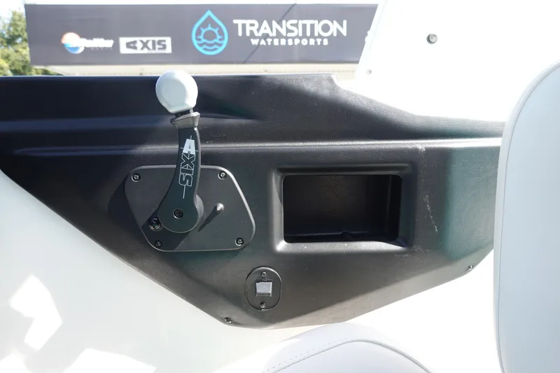 Slide: The Image of 2020 Axis T22 boat interior with control lever and storage compartment. - 24