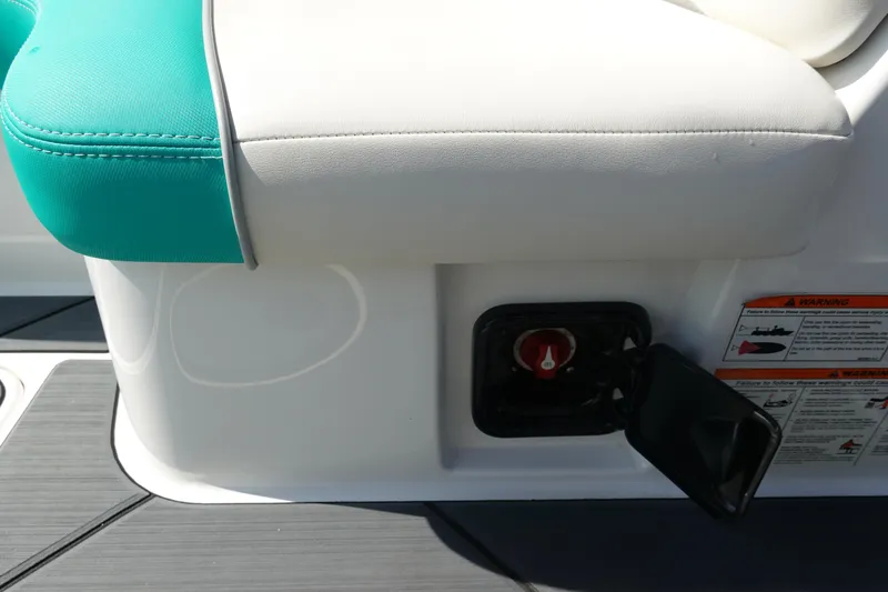 Slide: The Image of Axis T22 2020 boat seat with teal and white upholstery, featuring a control panel. - 26