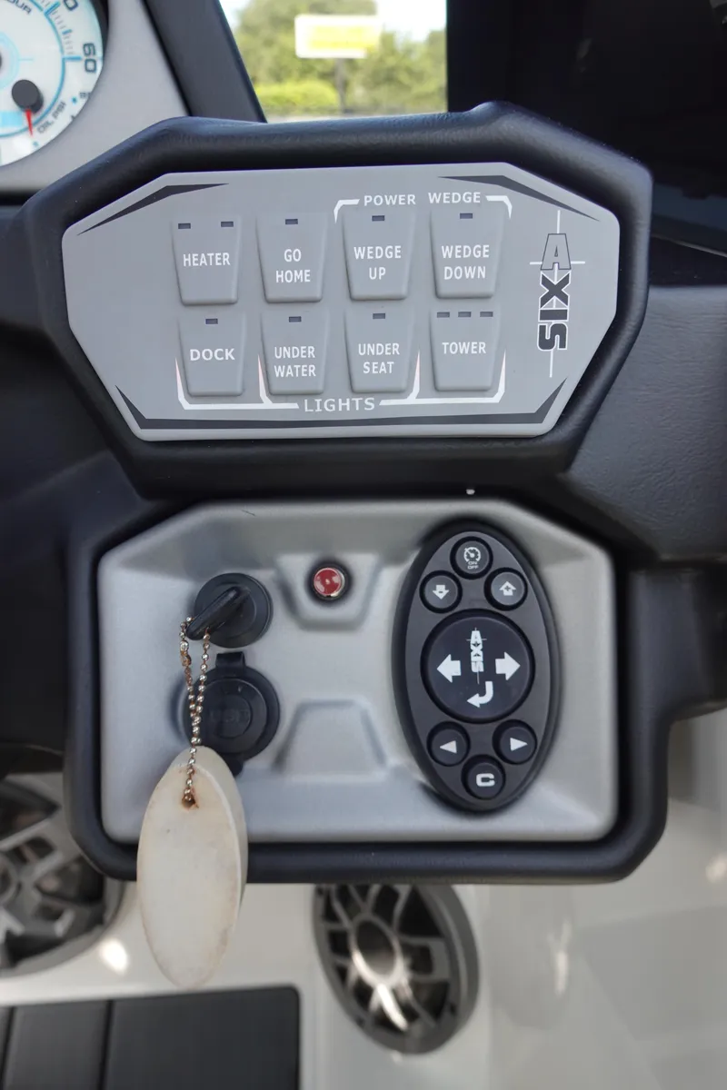 Slide: The Image of 2020 Axis T22 boat control panel with various function buttons and key ignition. - 29