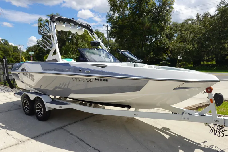 Slide: The Image of 2020 Axis T22 boat on trailer, sleek design, parked outdoors. - 3