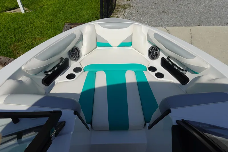 Slide: The Image of 2020 Axis T22 boat interior with teal and white seating, speakers, and cup holders. - 31