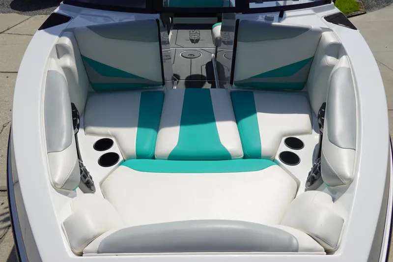 Slide: The Image of 2020 Axis T22 boat interior with teal and white seating, featuring cup holders and sleek design. - 33