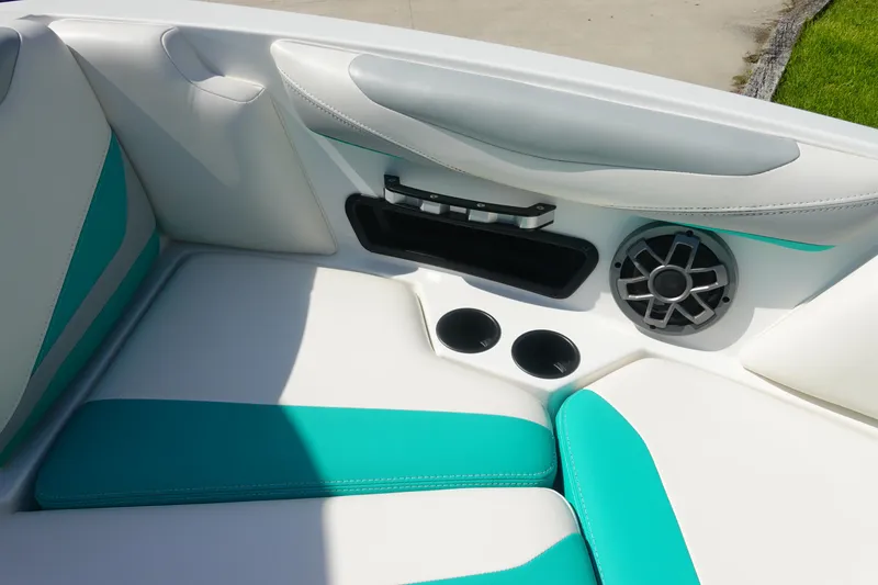 Slide: The Image of 2020 Axis T22 boat interior with teal accents, cup holders, and speaker. - 35