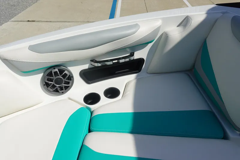 Slide: The Image of 2020 Axis T22 boat interior with teal and white seating, speaker, and cup holders. - 36