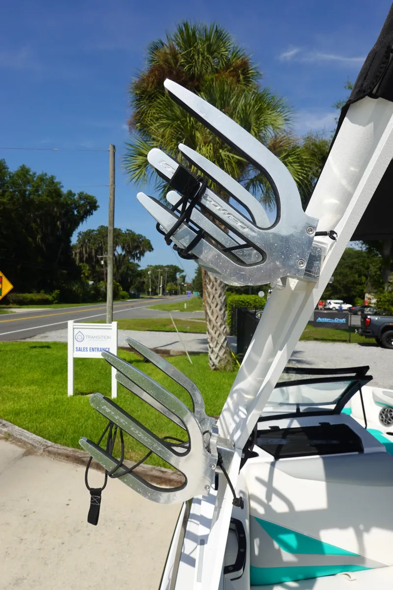 Slide: The Image of Axis T22 2020 boat with wakeboard racks, parked near palm trees. - 38