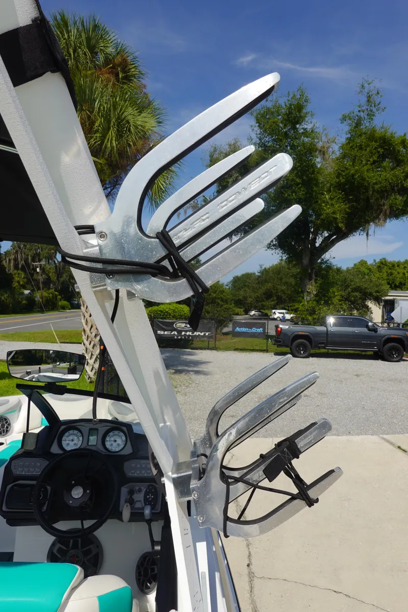 Slide: The Image of 2020 Axis T22 boat with wakeboard racks and steering wheel, parked outdoors. - 39