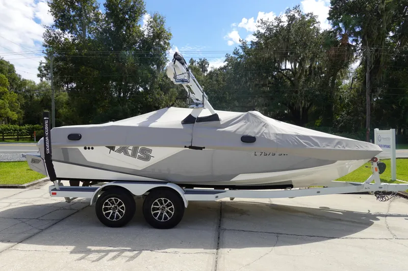 Slide: The Image of 2020 Axis T22 boat on trailer with cover, parked outdoors. - 4