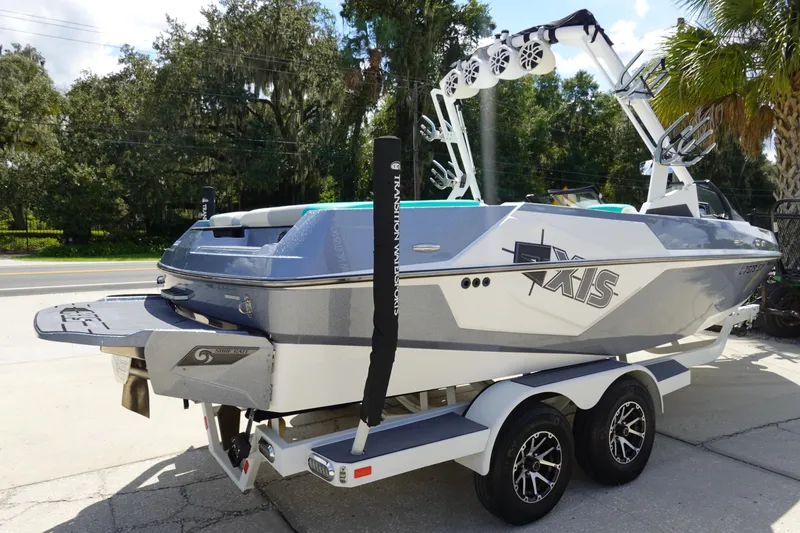 Slide: The Image of 2020 Axis T22 boat on trailer, gray and white, parked outdoors. - 5