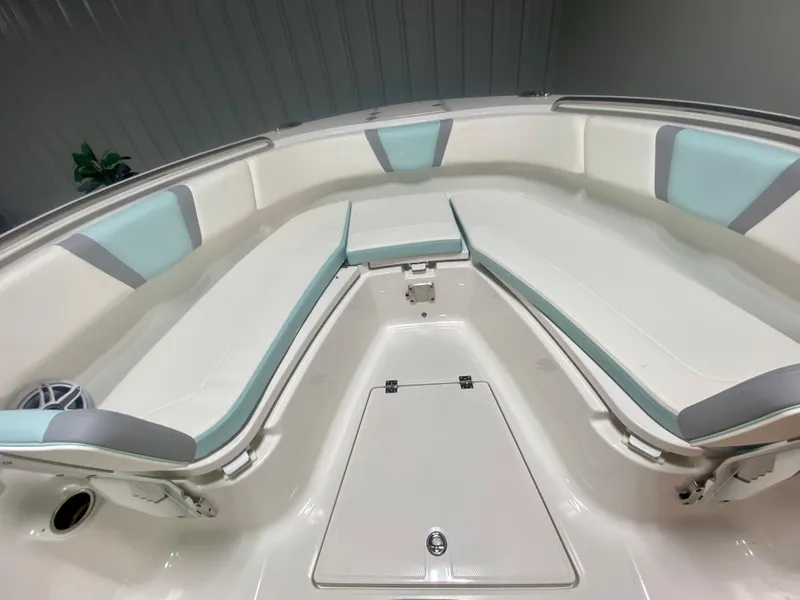 Slide: The Image of 2024 Robalo R270 boat interior with cushioned seating and storage compartments. - 27